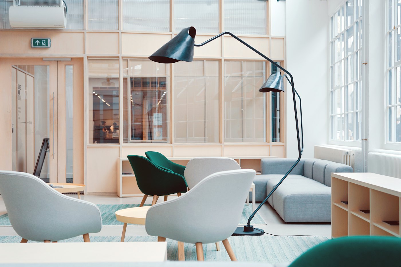 Office breakout lounge with designer chairs and glass partitions