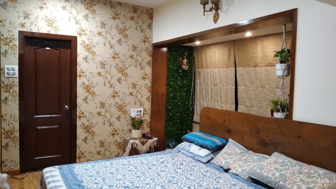 Bedroom with floral wallpaper, upholstered bed and wood-grain wardrobe
