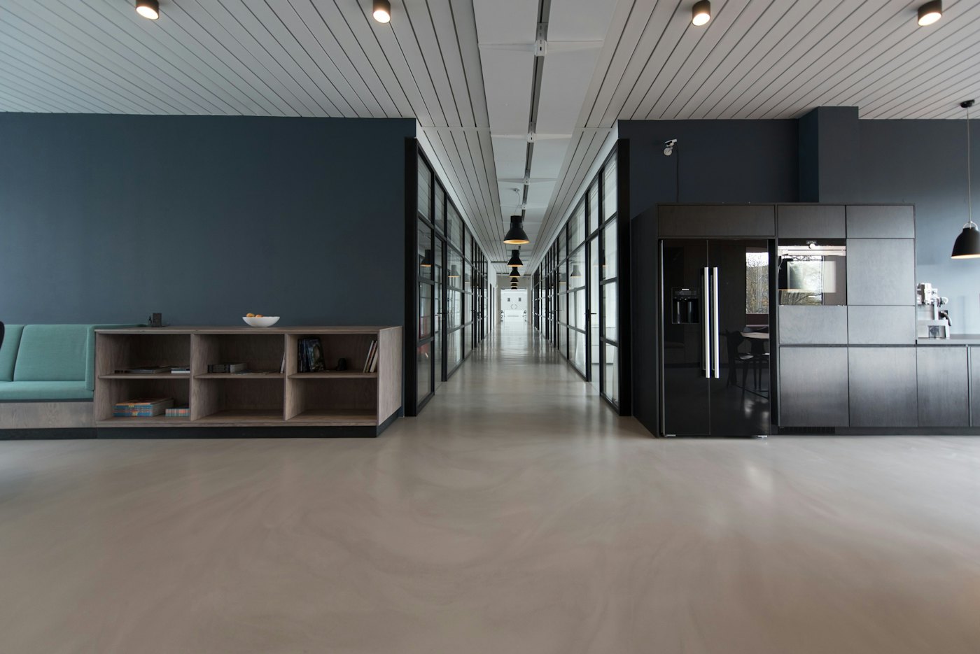 Office corridor with storage units and glass partitions