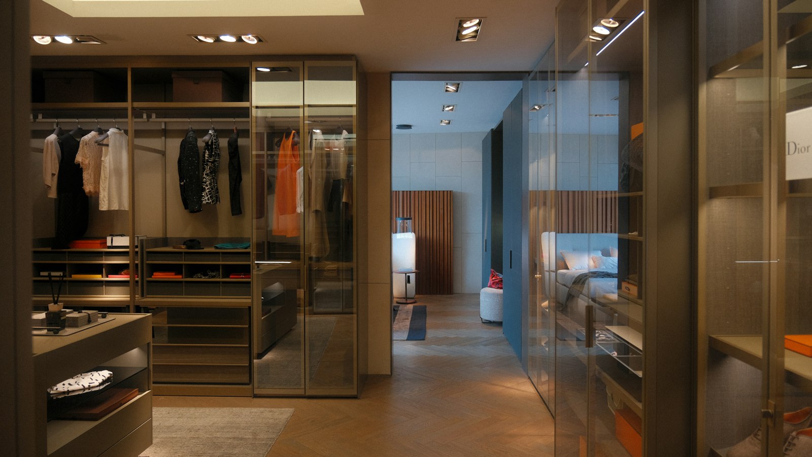 Walk-in dressing room with full-height tinted-glass wardrobe cabinets and lit shelves