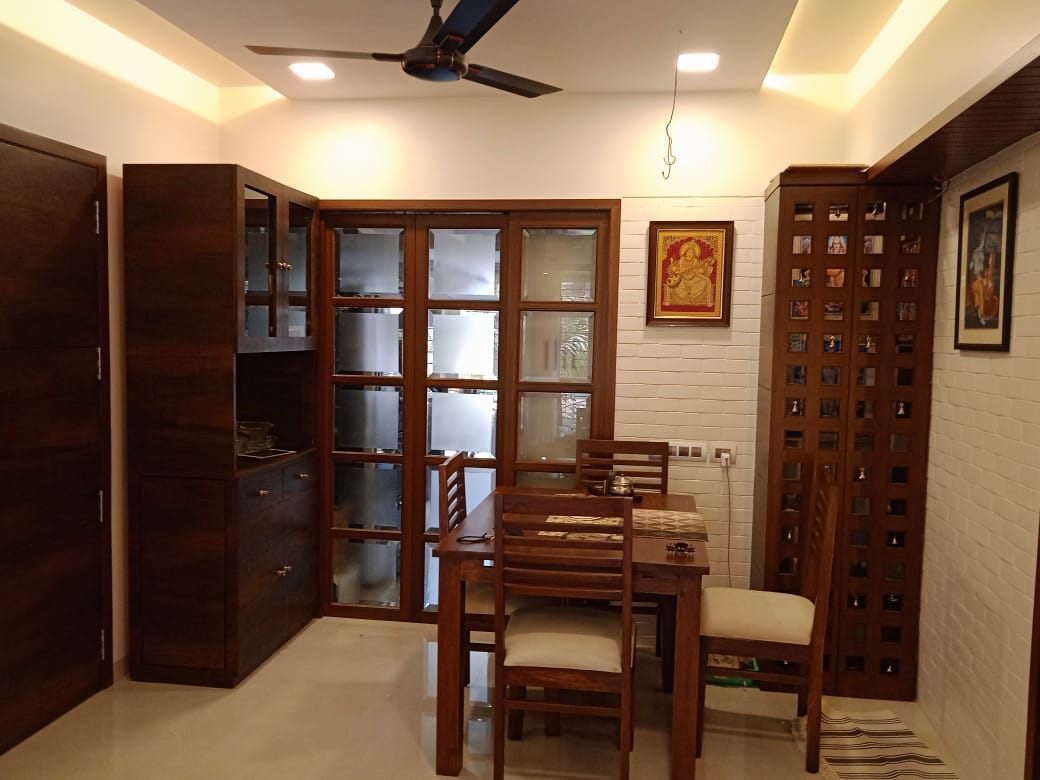 Dining area with walnut crockery unit and jali screen