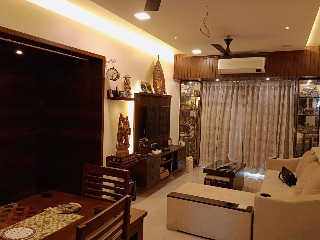 Living and dining zones under a cove-lit false ceiling