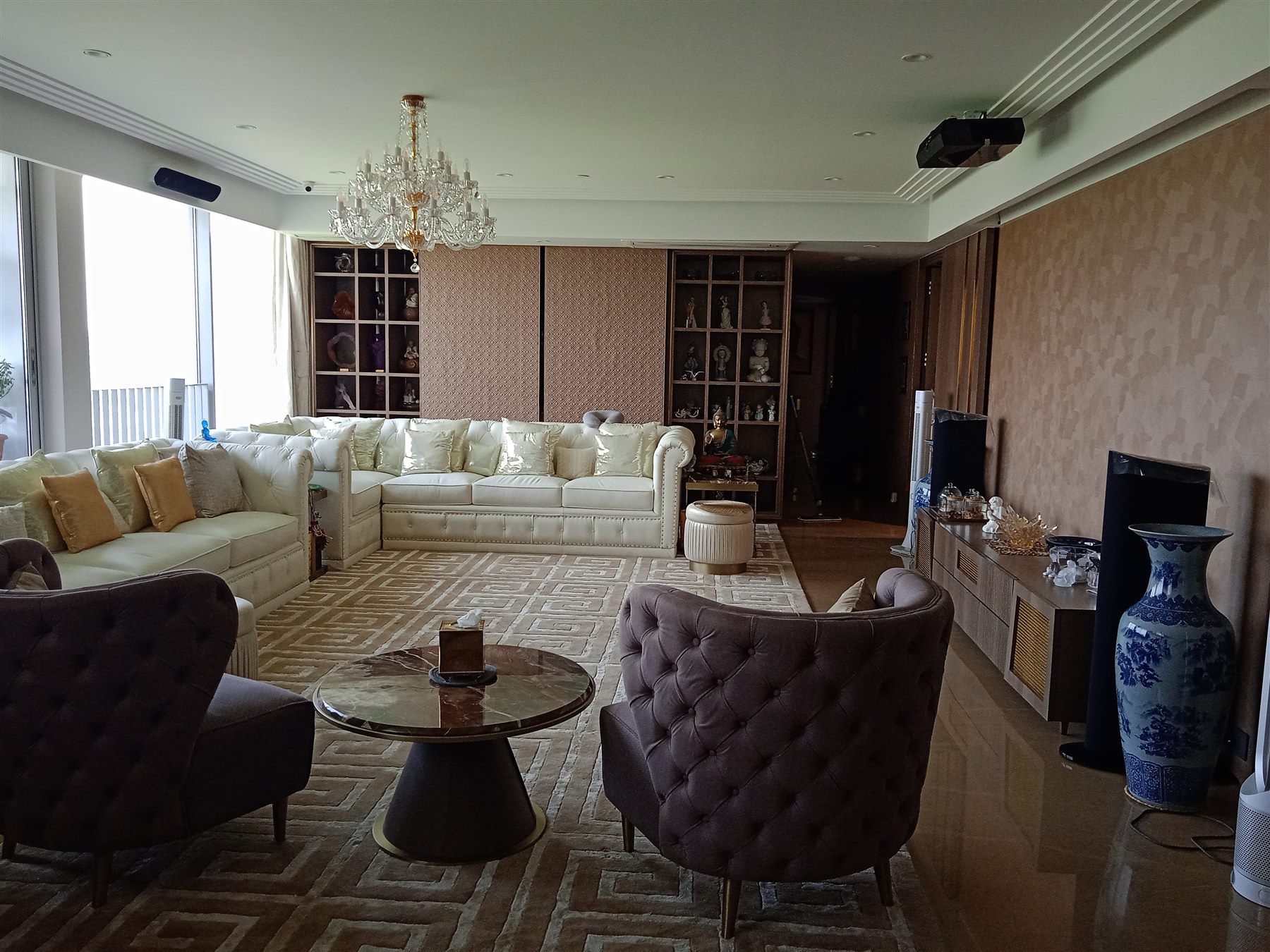 Seating area with tufted armchairs and a long sofa