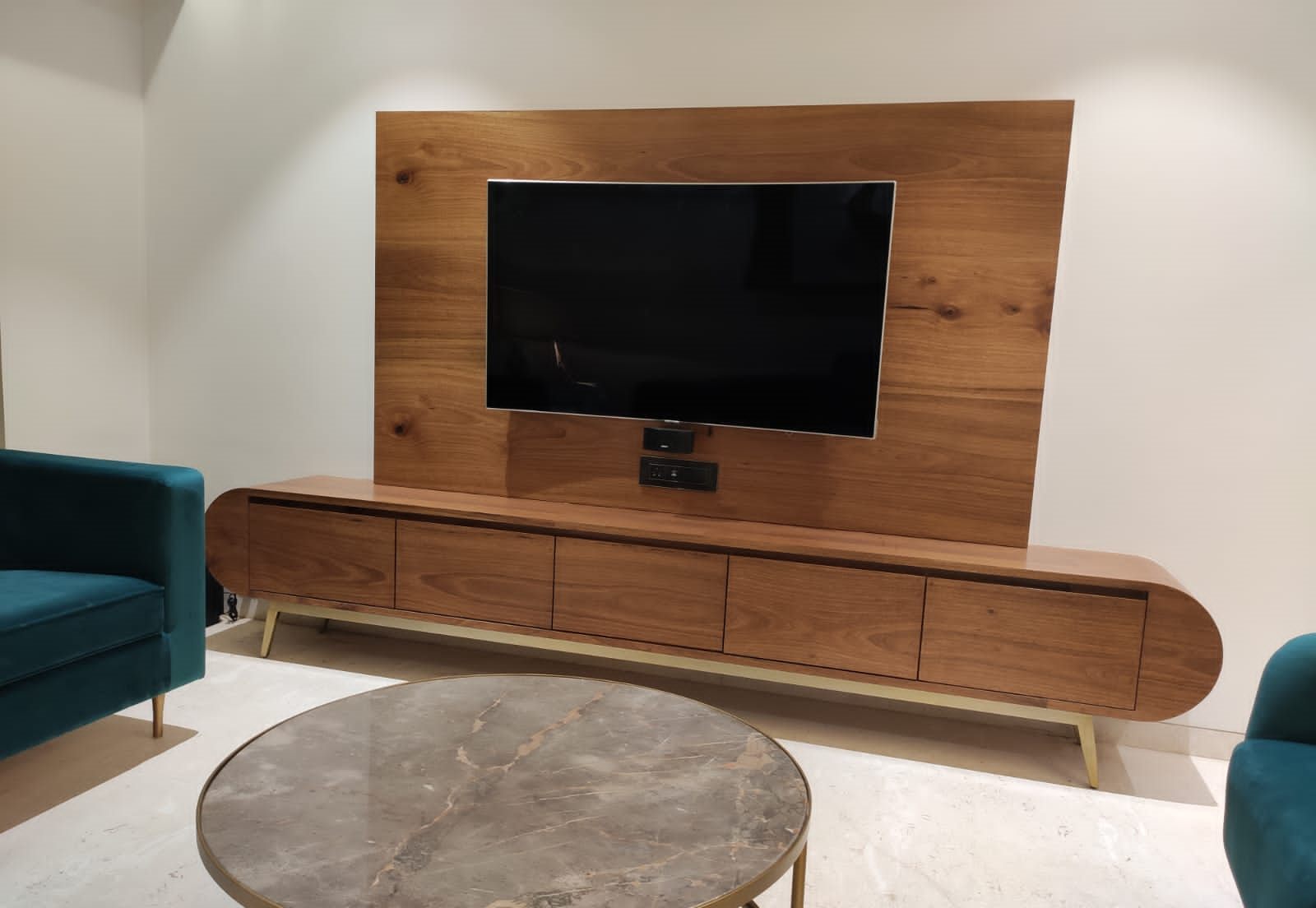 Walnut TV unit with a round marble-top coffee table